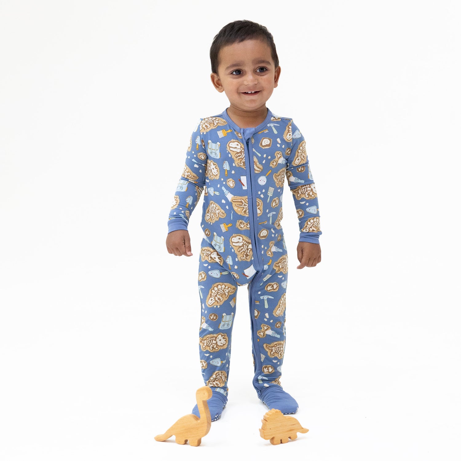 Convertible baby romper with glow-in-the-dark dinosaur dig print, two-way zipper, and foot cuffs
