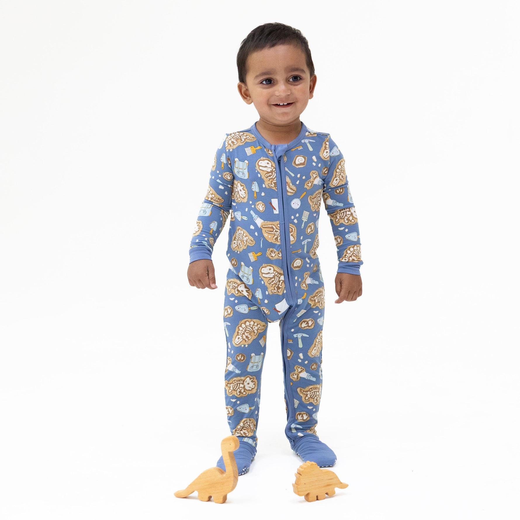 Convertible baby romper with glow-in-the-dark dinosaur dig print, two-way zipper, and foot cuffs