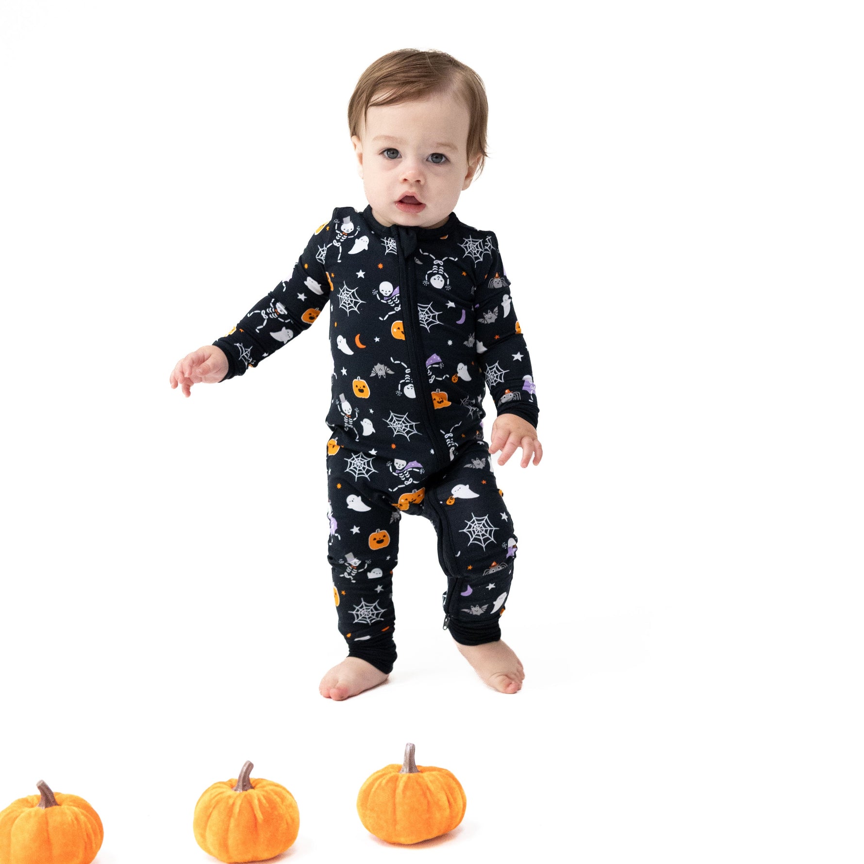 Baby convertible zip romper with skeleton print, two-way zipper, foot grippers and fold-over cuffs