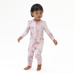 Convertible romper with a painterly rose bouquet print in soft pink and green tones, featuring a full-length zipper.