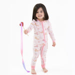 Convertible romper with unicorns and castle print, front zipper, chin guard, and foot grippers