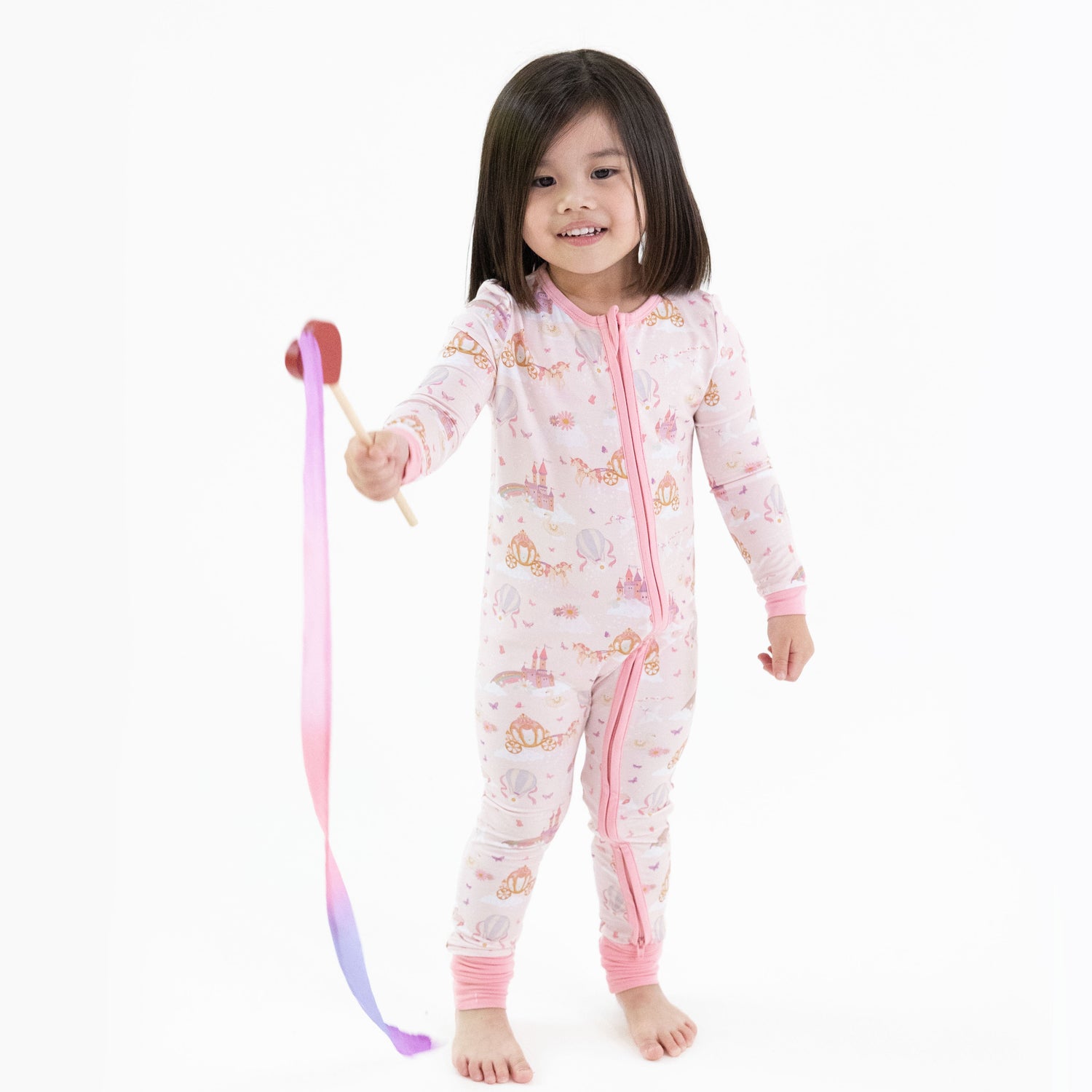 Convertible romper with unicorns and castle print, front zipper, chin guard, and foot grippers