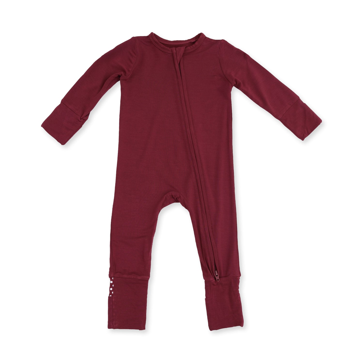 Convertible romper in solid oxblood red with a full-length two-way zipper and foot cuffs.