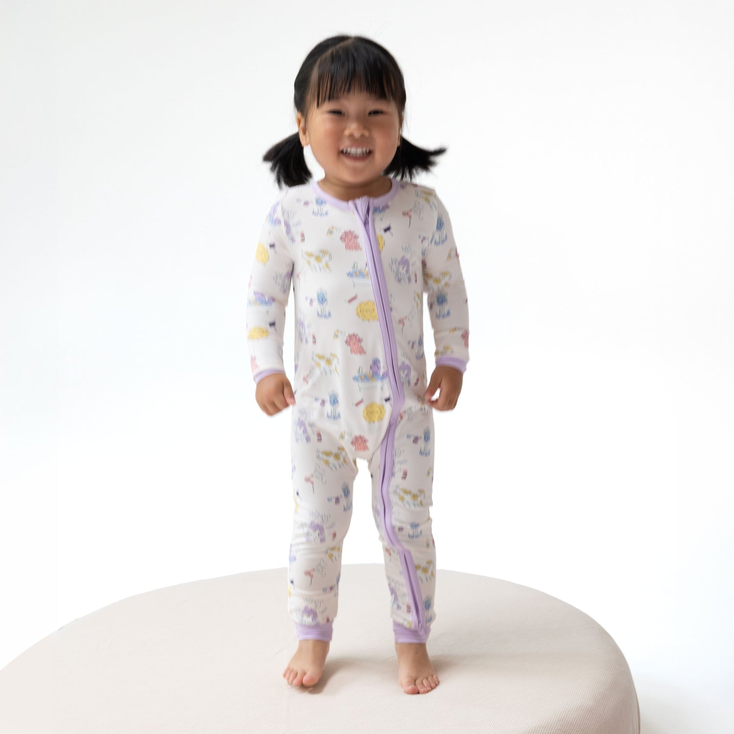 Convertible baby romper in a Spa Dogs print with two-way zipper, foot grippers, and fold-over foot cuffs.
