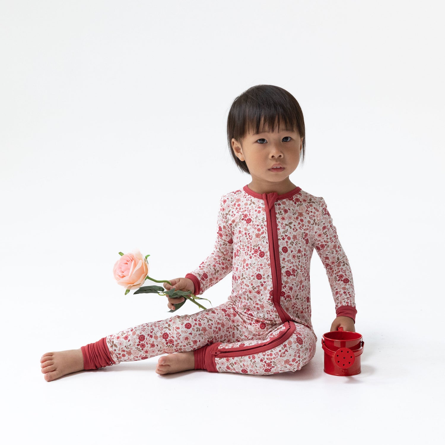 Convertible romper in a soft Serene Floral print with delicate blooms, two-way zipper, and foot grippers.