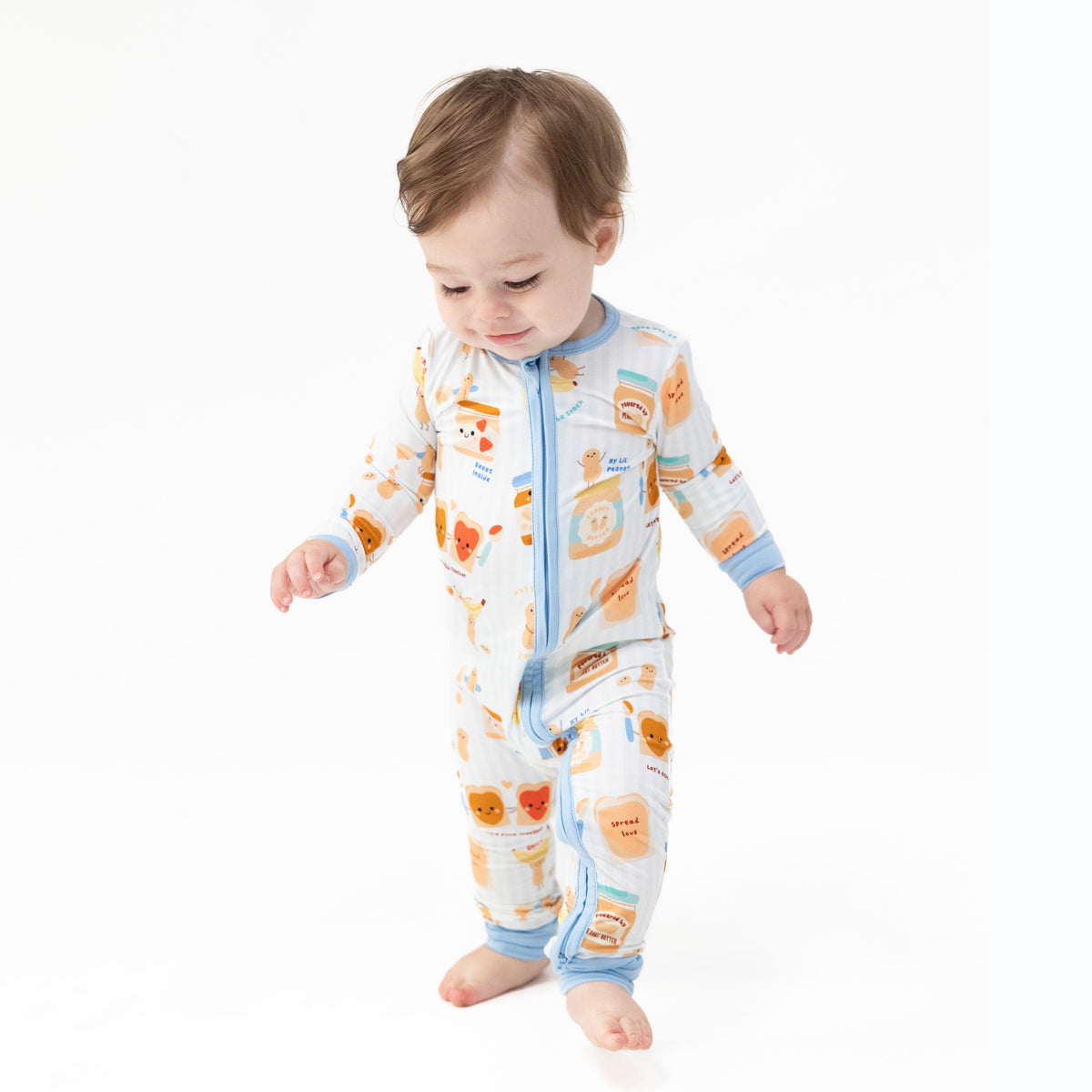 Convertible baby romper in a Spread the Love heart print with a front zipper and foot cuffs