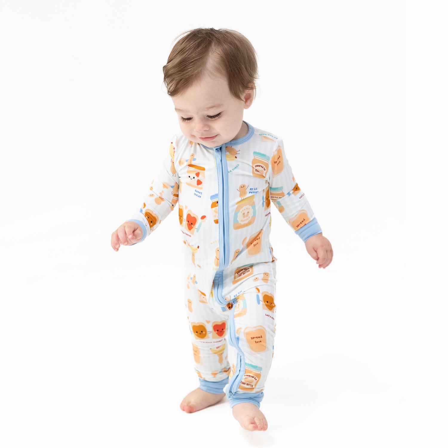Convertible baby romper in a Spread the Love heart print with a front zipper and foot cuffs