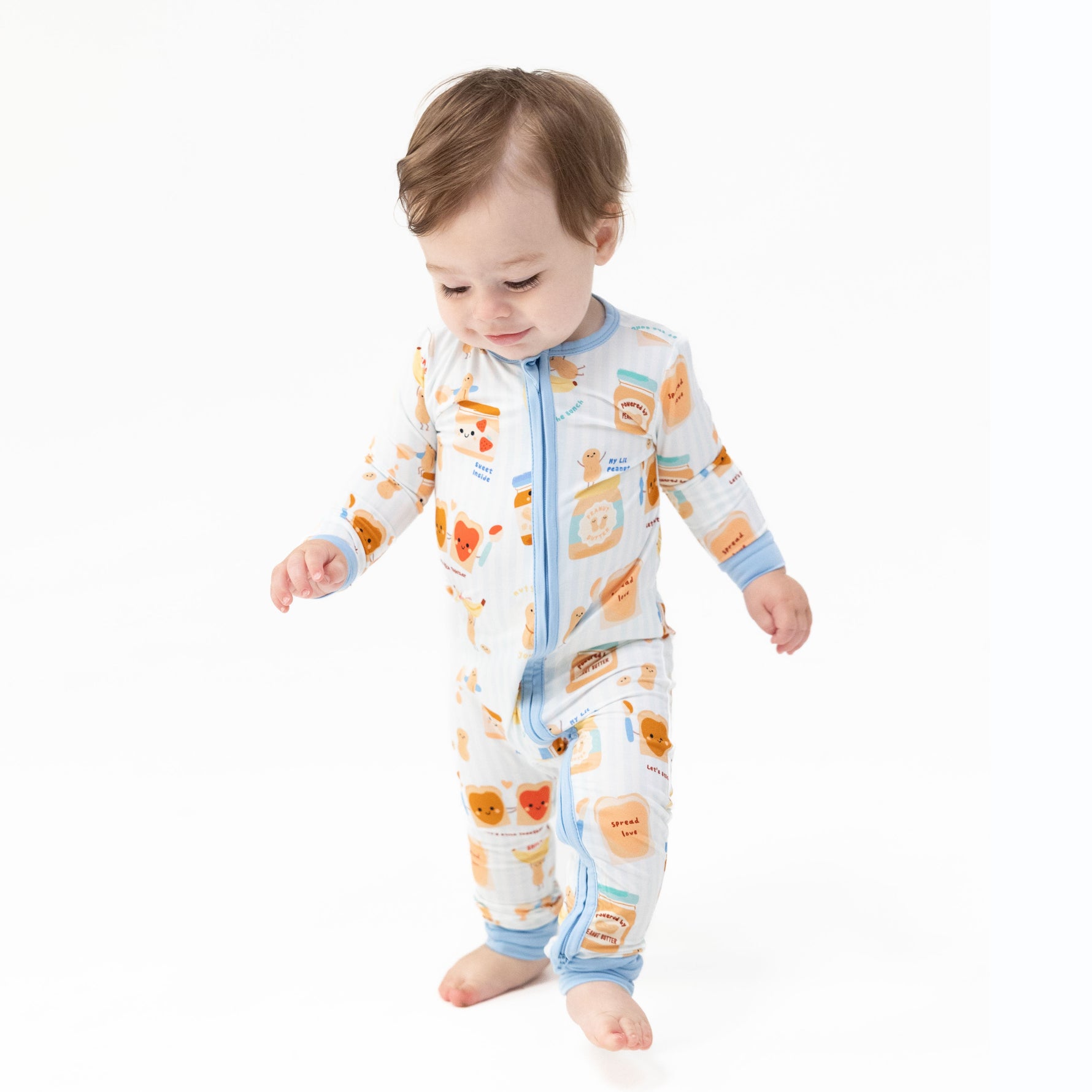Convertible baby romper in a Spread the Love heart print with a front zipper and foot cuffs