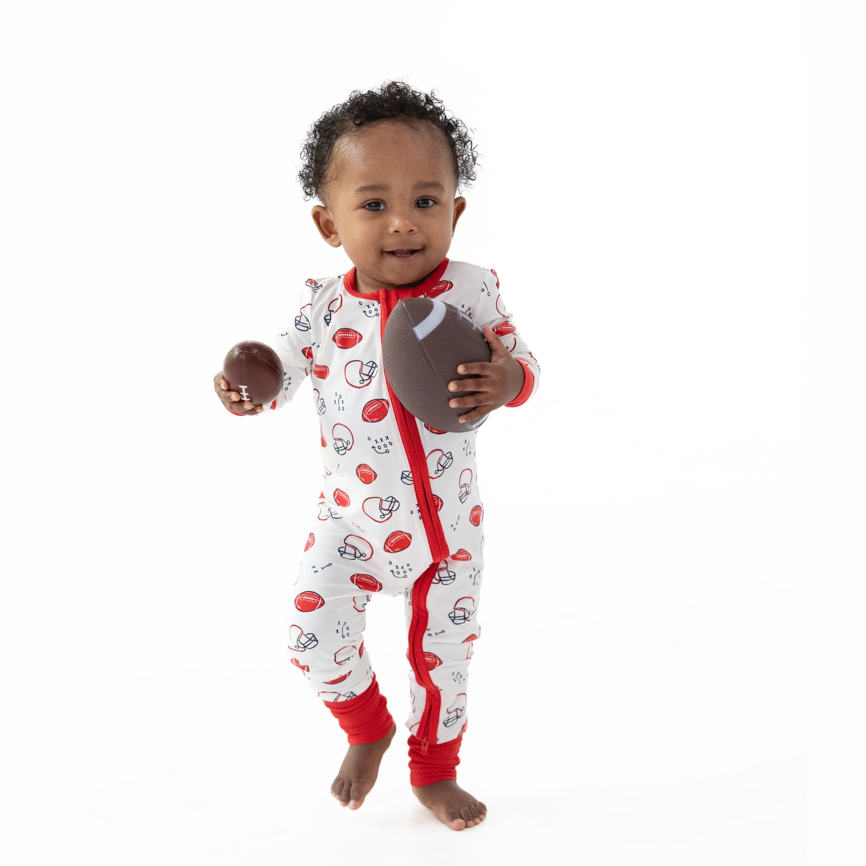 Convertible romper with two-way zipper, fold-over foot cuffs, and football art print