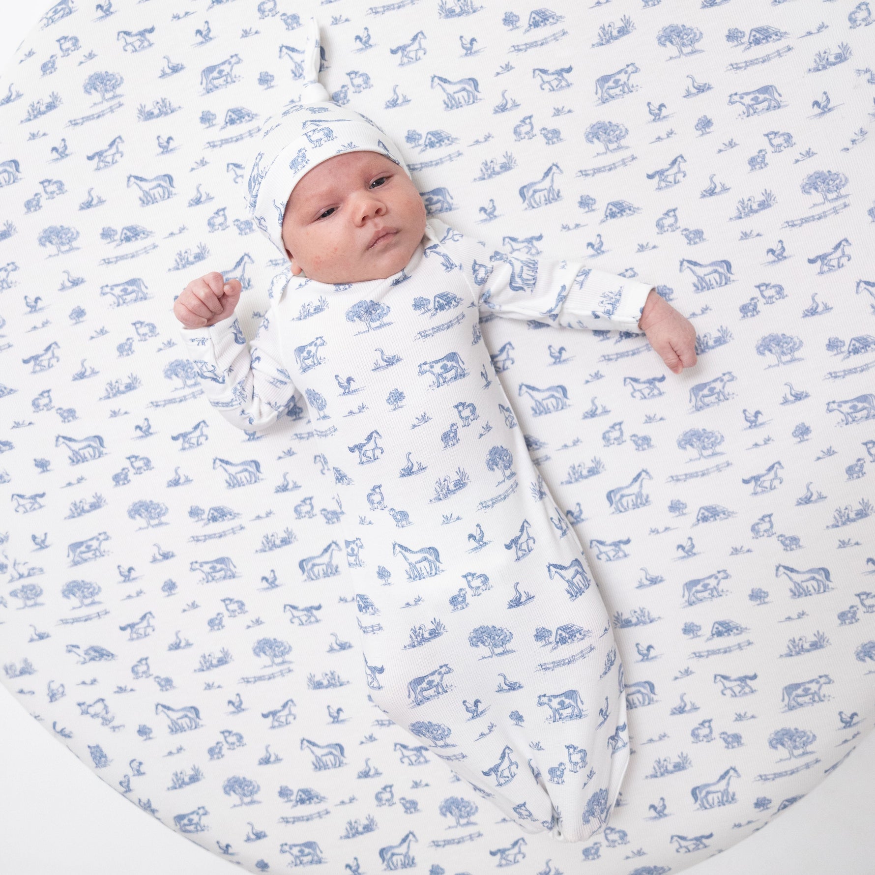 Knotted baby gown and matching knotted hat in a farm friends print on soft ribbed fabric