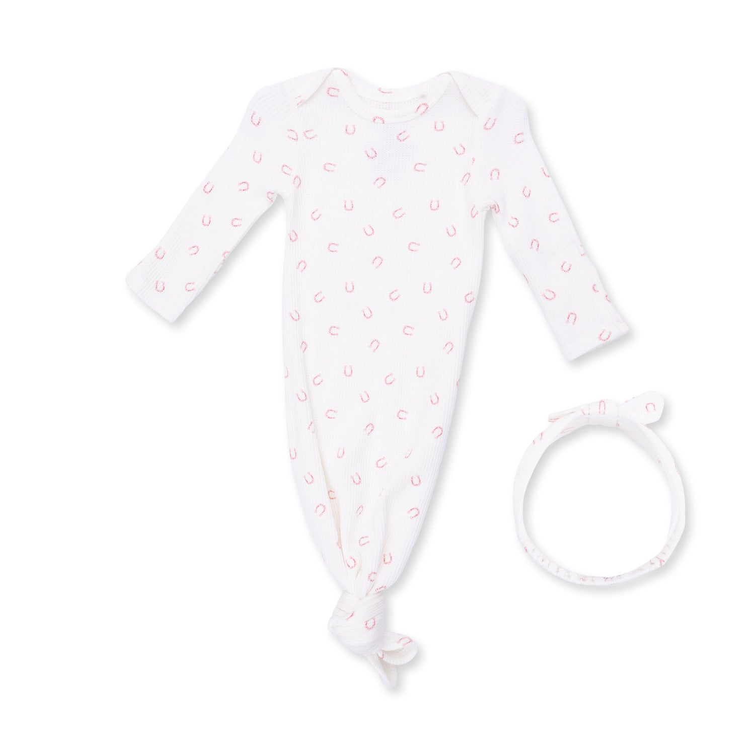 Pink knotted baby gown with little horseshoe print in waffle fabric, shown with a matching knot headband.