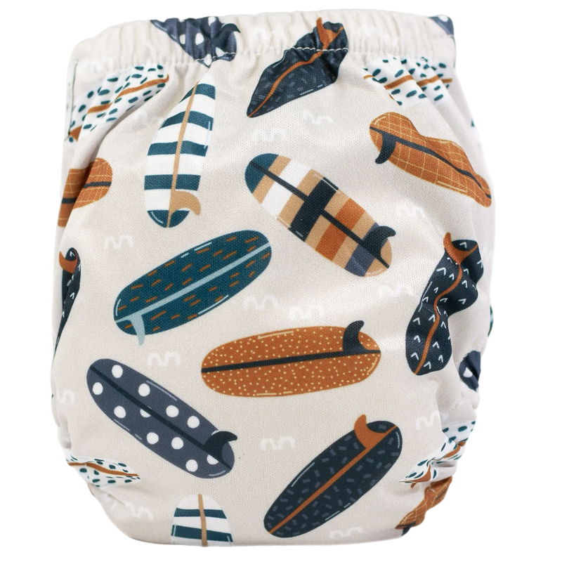 Tiny Tushies Newborn AIO Cloth Diaper with surfboard pattern, fits 5-20 lbs, water-resistant PUL material, and secure snap closures.