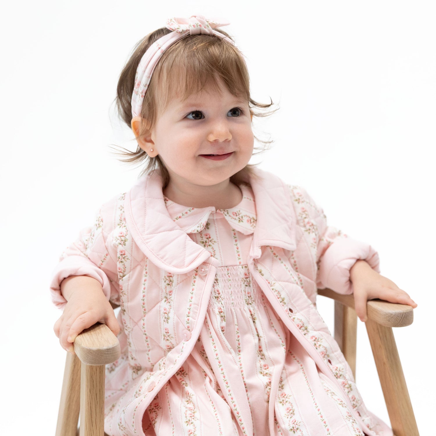 Quilted baby jacket in Antoinette Stripe pattern with long sleeves and front closure