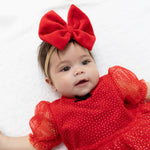 Baby headband with a velour bow on a stretchy nylon band