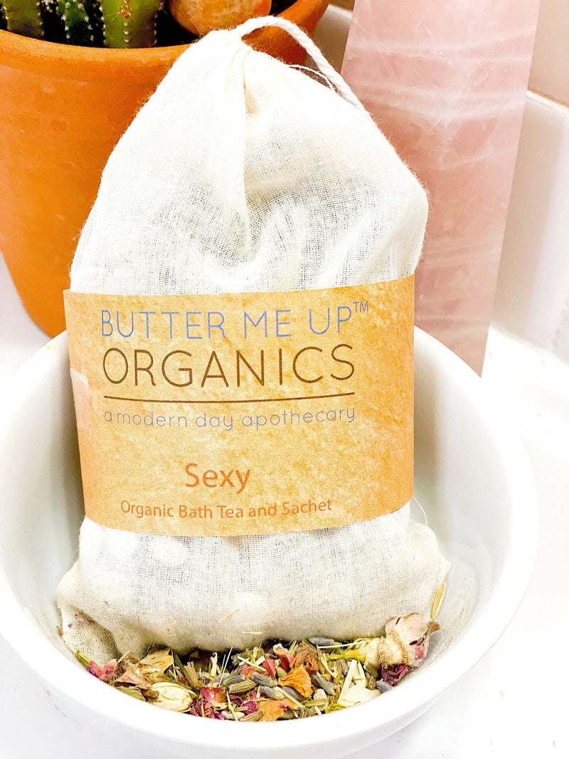 Organic bath tea sachet with rose petals, jasmine, lavender, oat straw, and burdock root in a muslin bag for a sensual aromatherapy bath.