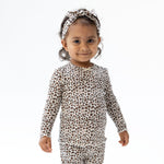 Long sleeve tunic top in leopard-print ribbed fabric with scalloped lettuce-edge cuffs and hem.
