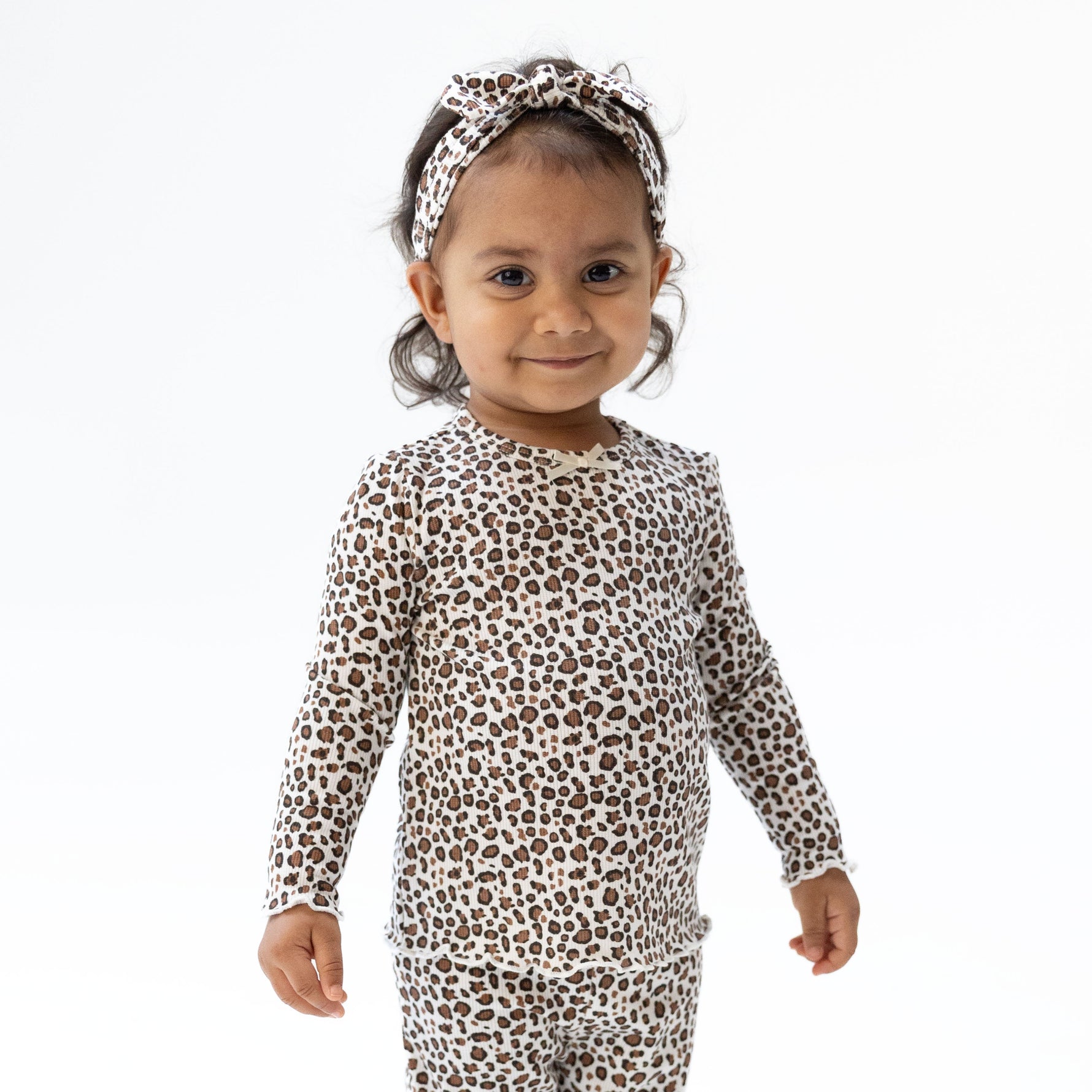 Long sleeve tunic top in leopard-print ribbed fabric with scalloped lettuce-edge cuffs and hem.