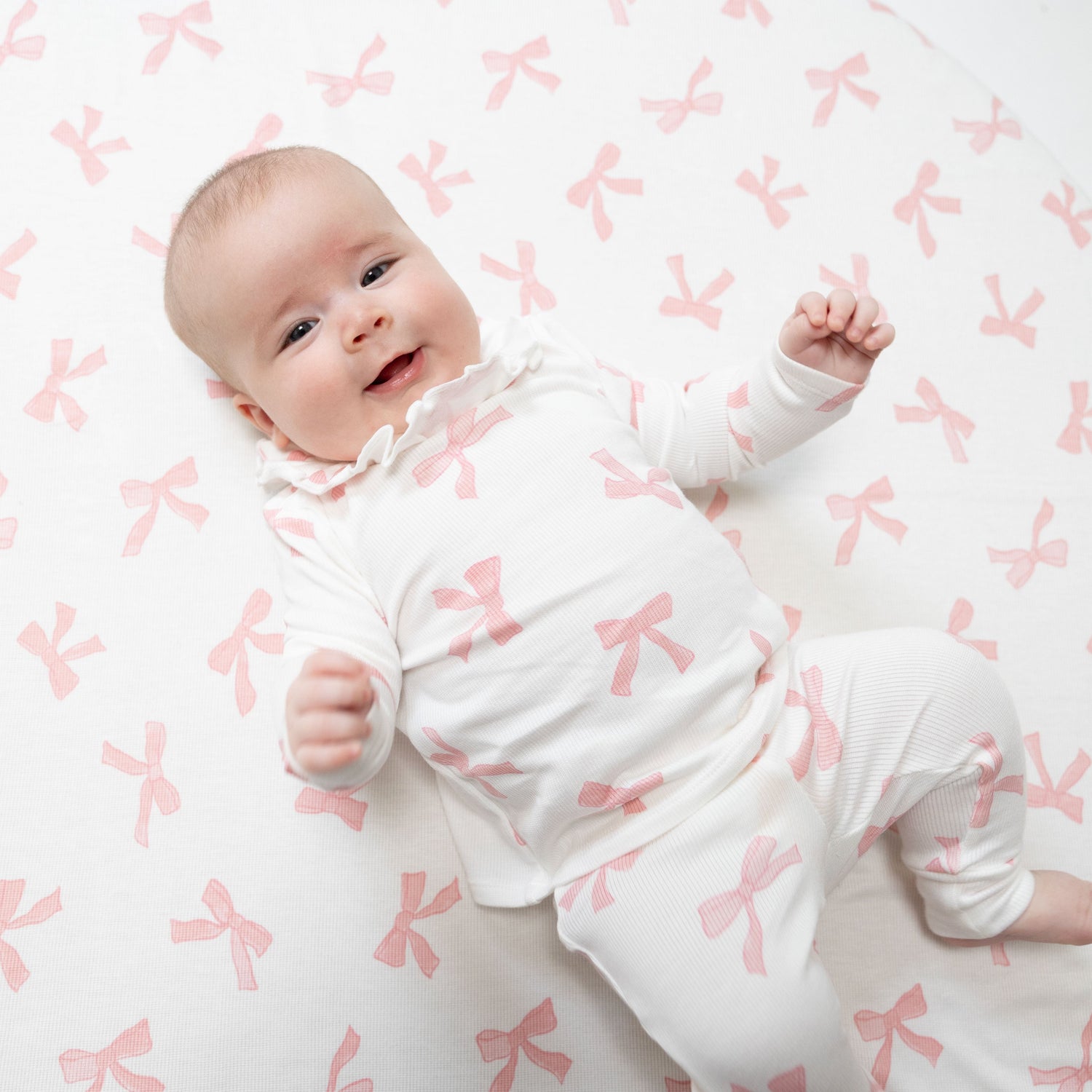 Two-piece baby set with long-sleeve ruffle-collar top and matching pants in a Pretty Bows print