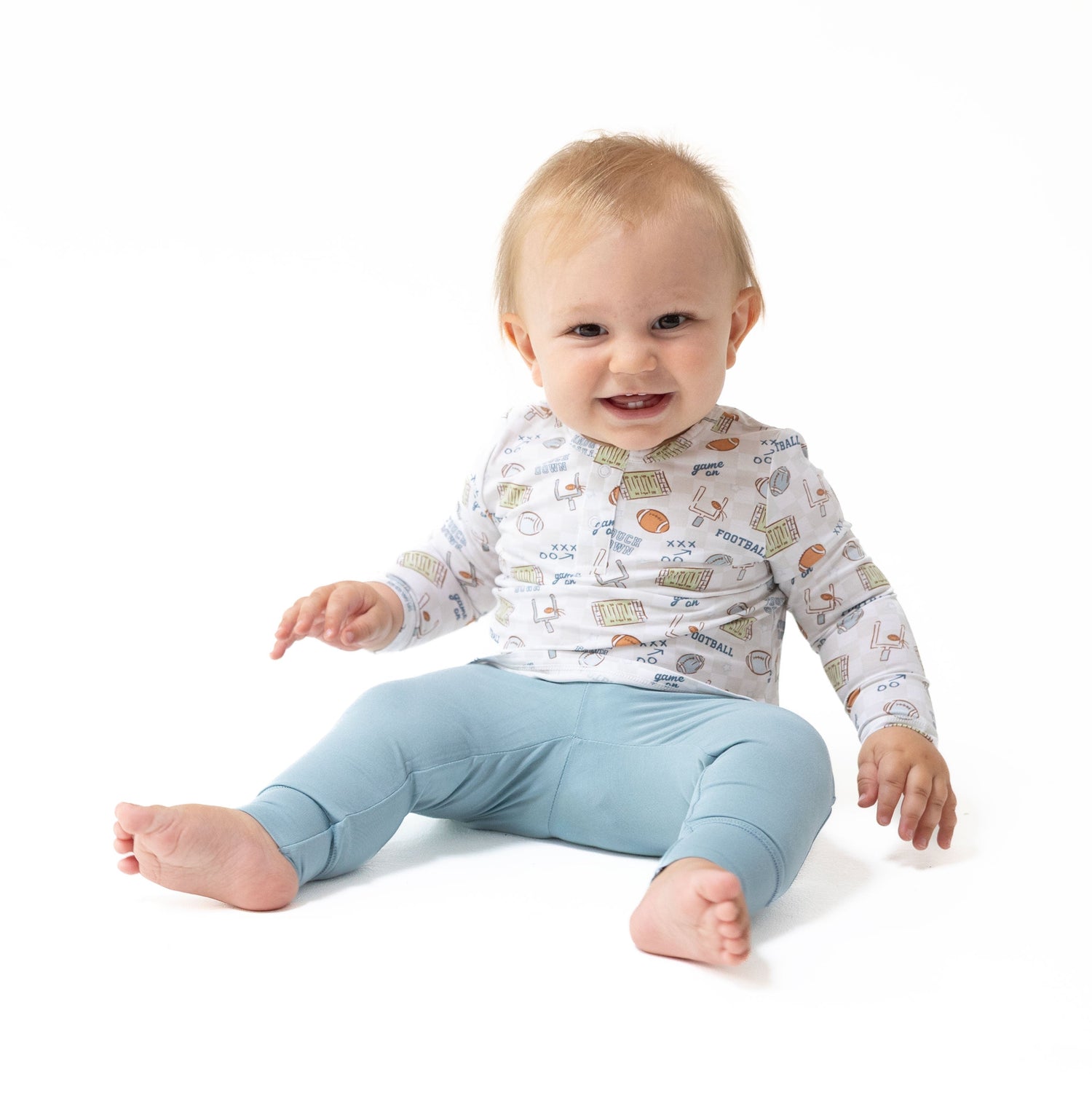Long sleeve henley and matching pants in football check print with snap opening at the neck.