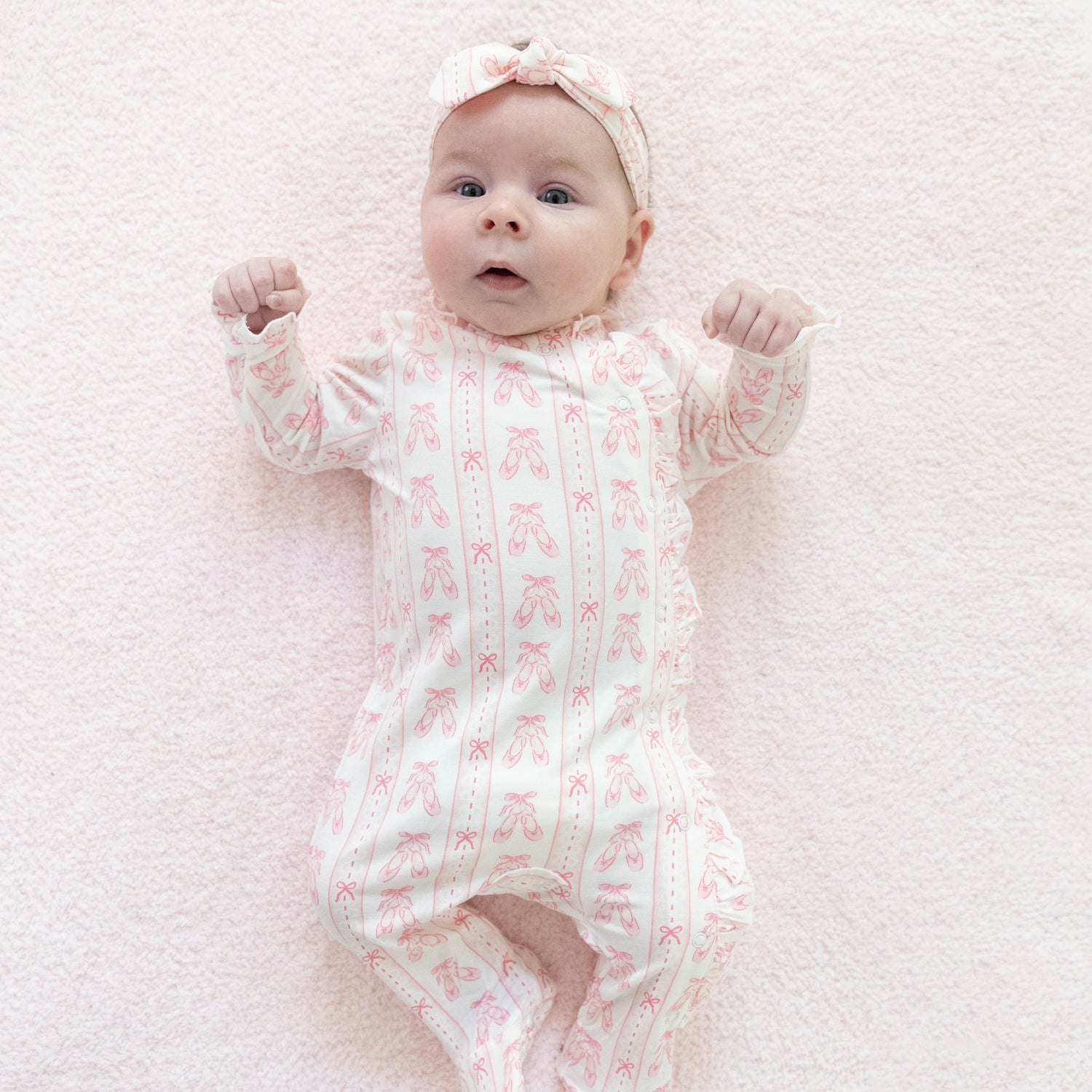 Kimono-style baby footie in pink ribbon stripe with ruffle wrap front, snap closures, and covered feet