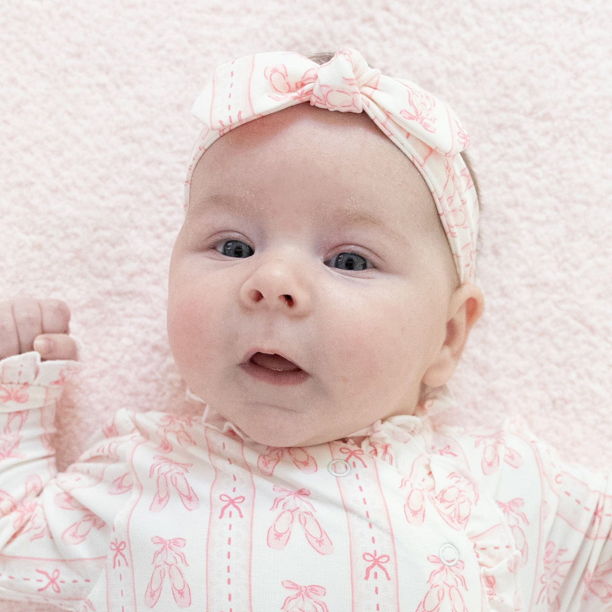 Baby knot headband in a ballet shoes and ribbon stripe print with a knot detail at the front.