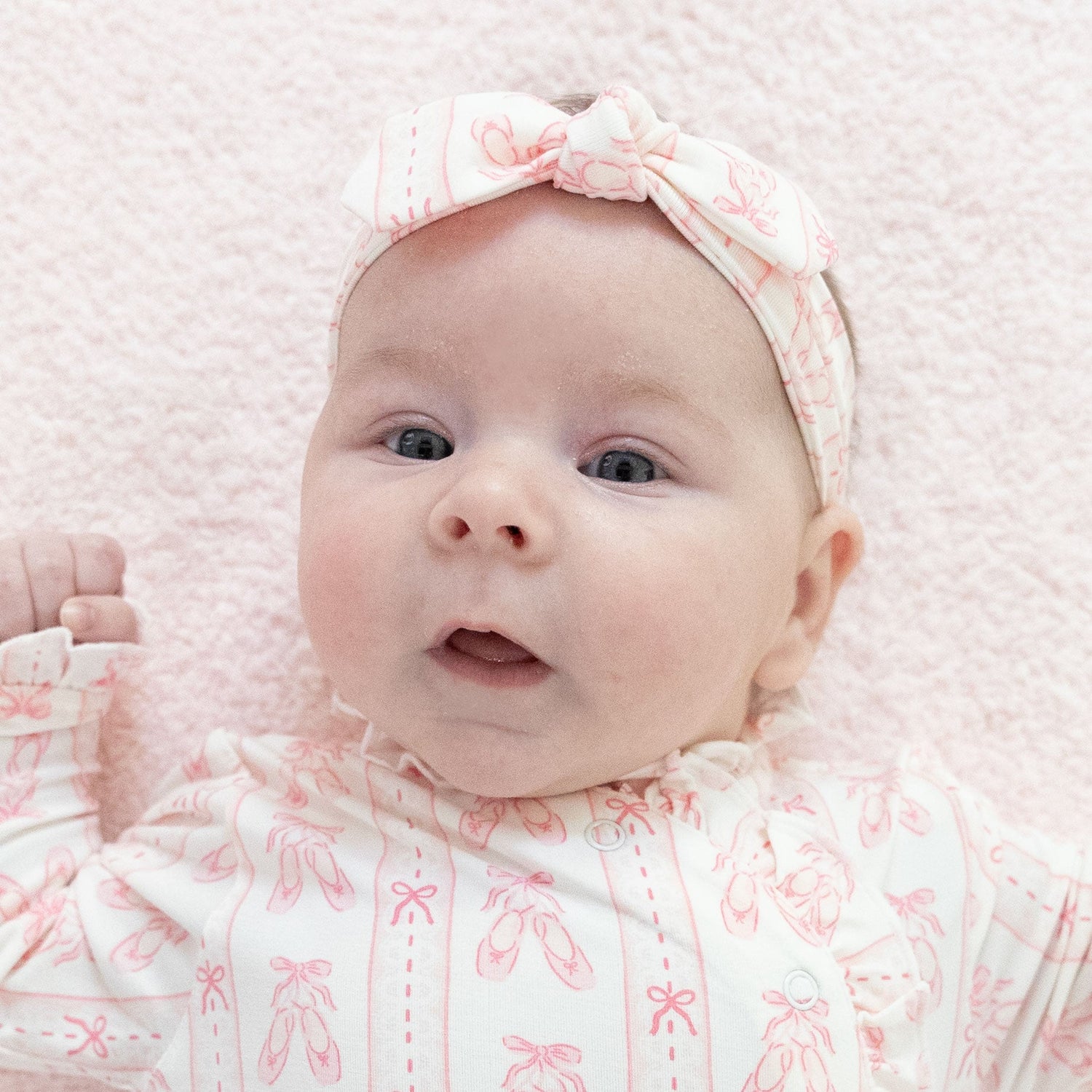 Baby knot headband in a ballet shoes and ribbon stripe print with a knot detail at the front.