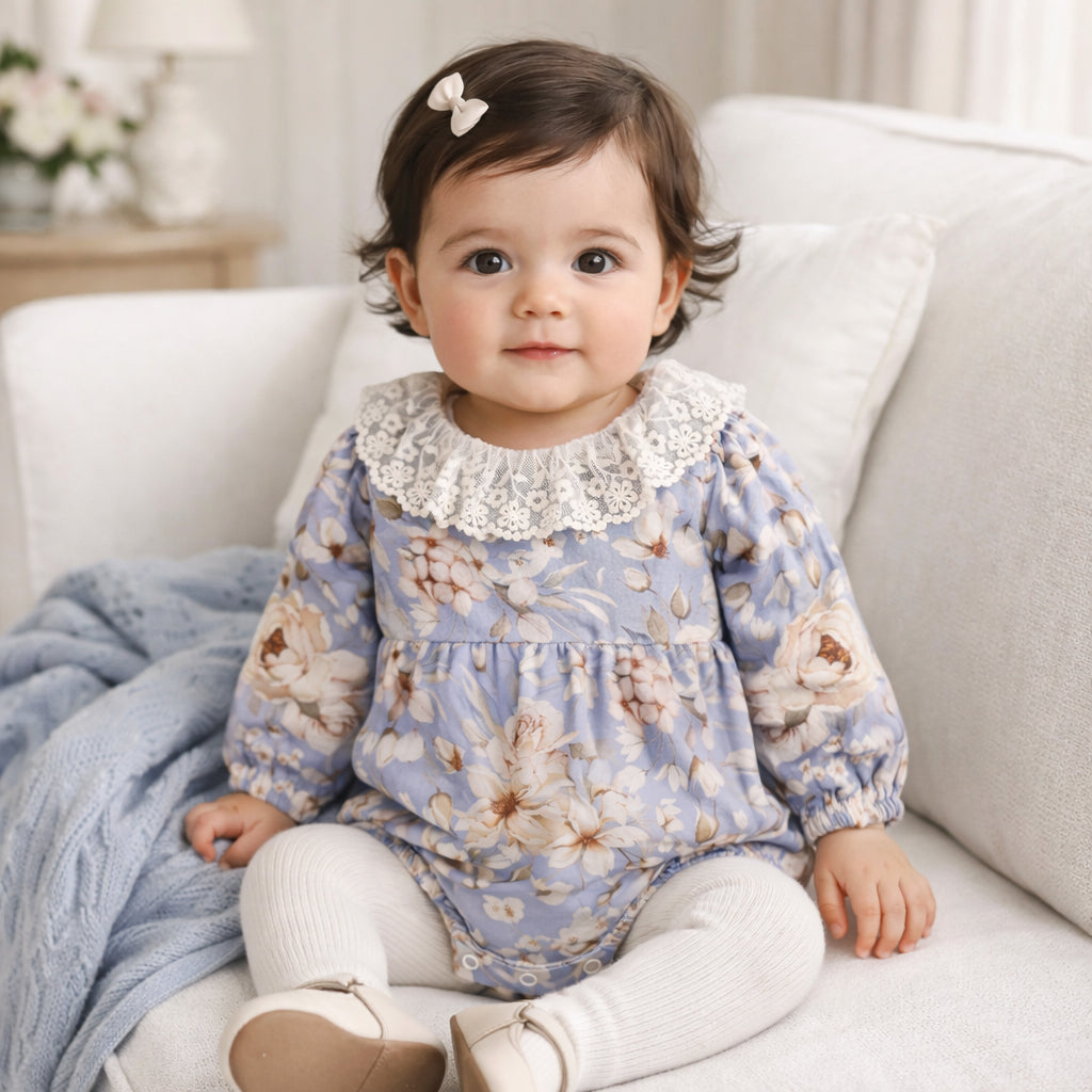 Baby bodysuit in blue and cream vintage floral print with scalloped lace collar and ruffled leg hems
