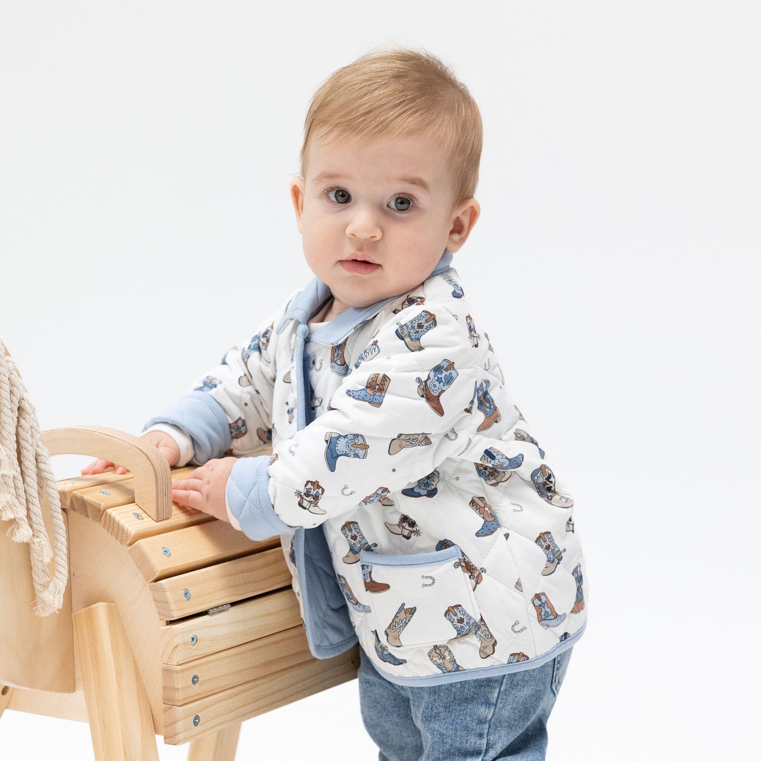 Baby barn jacket in Buckaroo Boots print with contrast collar and trim, snap front opening and two front pockets