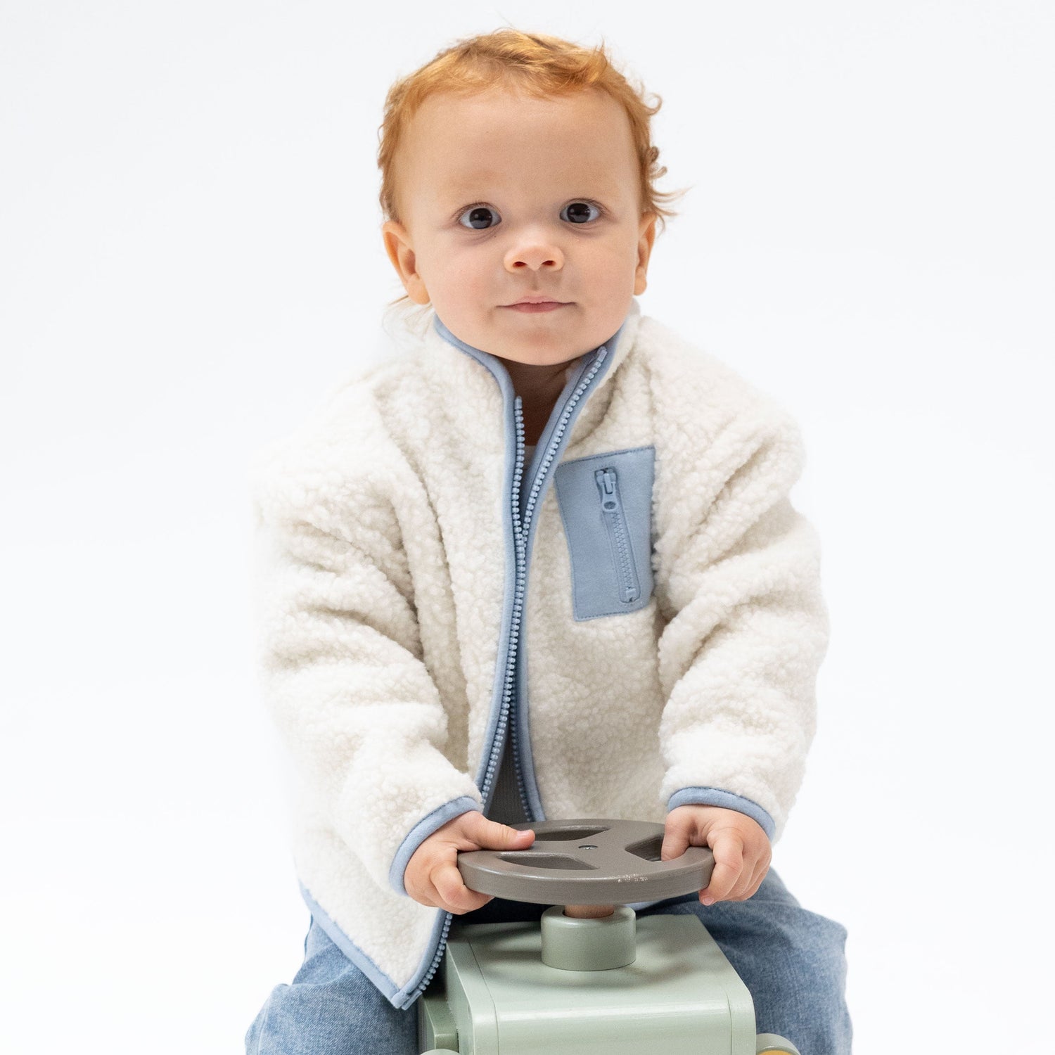 Sherpa baby zip jacket with fuzzy outer, contrast trim, full front zip, and a small zip pocket