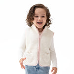 Sleeveless sherpa zip vest with heart-shaped front pockets and contrast piping trim.