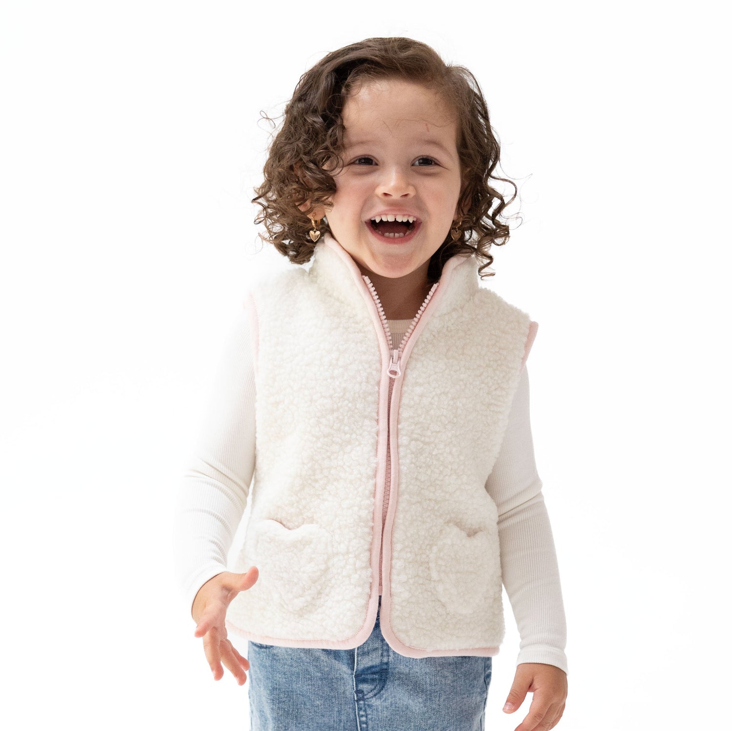 Sleeveless sherpa zip vest with heart-shaped front pockets and contrast piping trim.