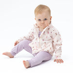 Baby mock neck active jacket with two front pockets and ruffle trim along the back