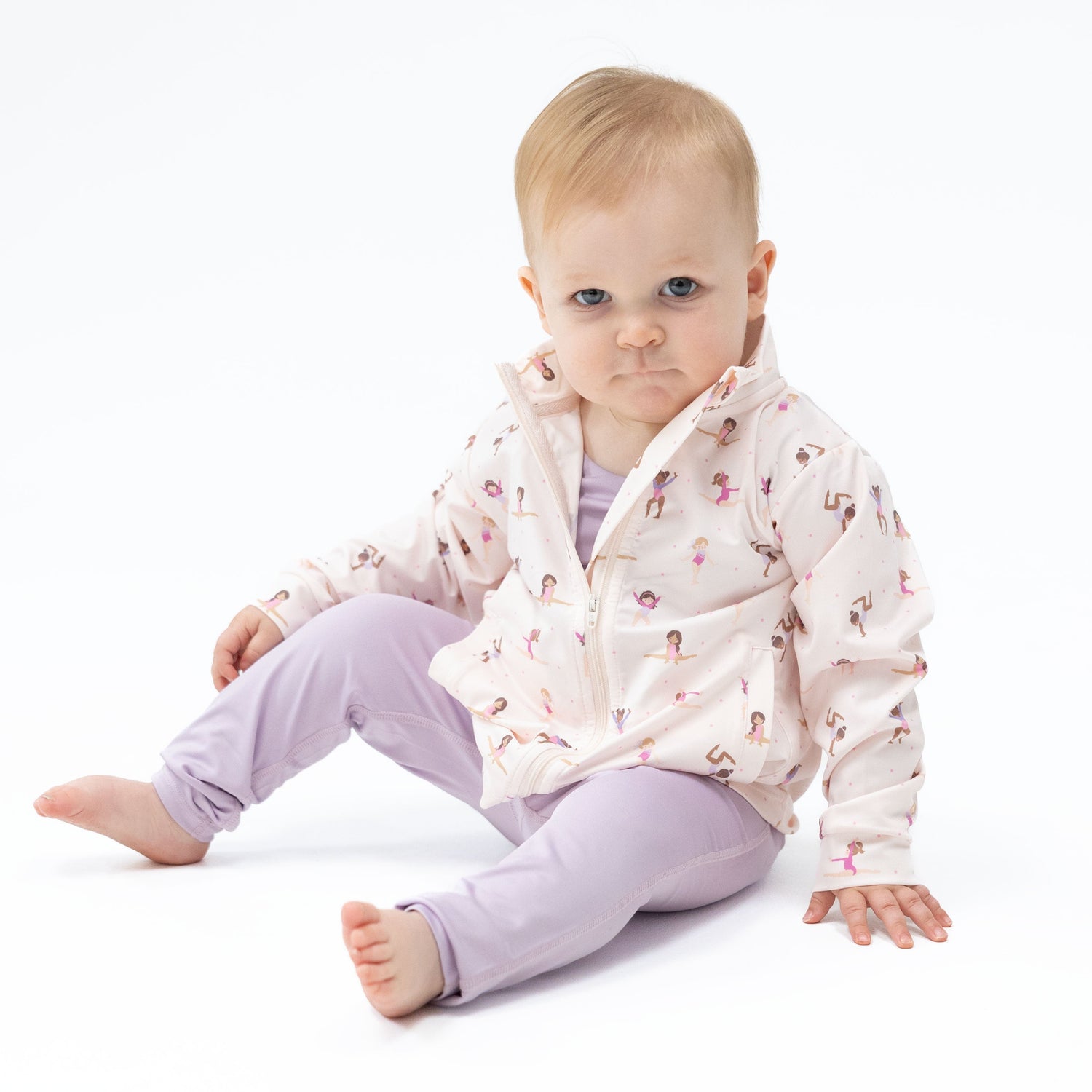 Baby mock neck active jacket with two front pockets and ruffle trim along the back