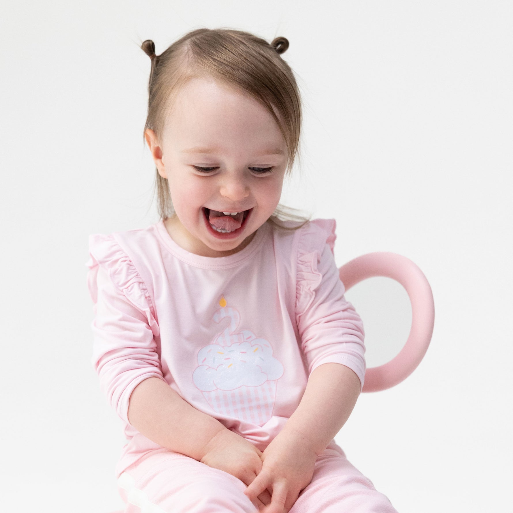 Long sleeve toddler ruffle top with screenprinted birthday cupcake and a number 2 candle