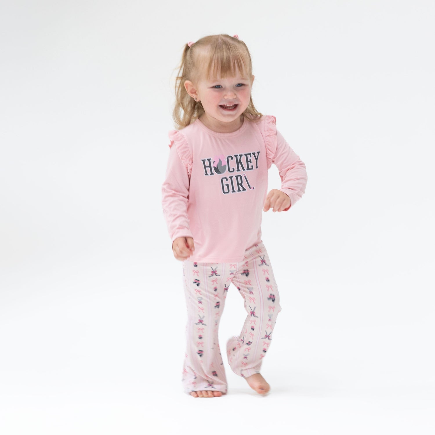 Baby two-piece set: long-sleeve ruffle tee with Hockey Girl puff print and matching bell-bottom pants.