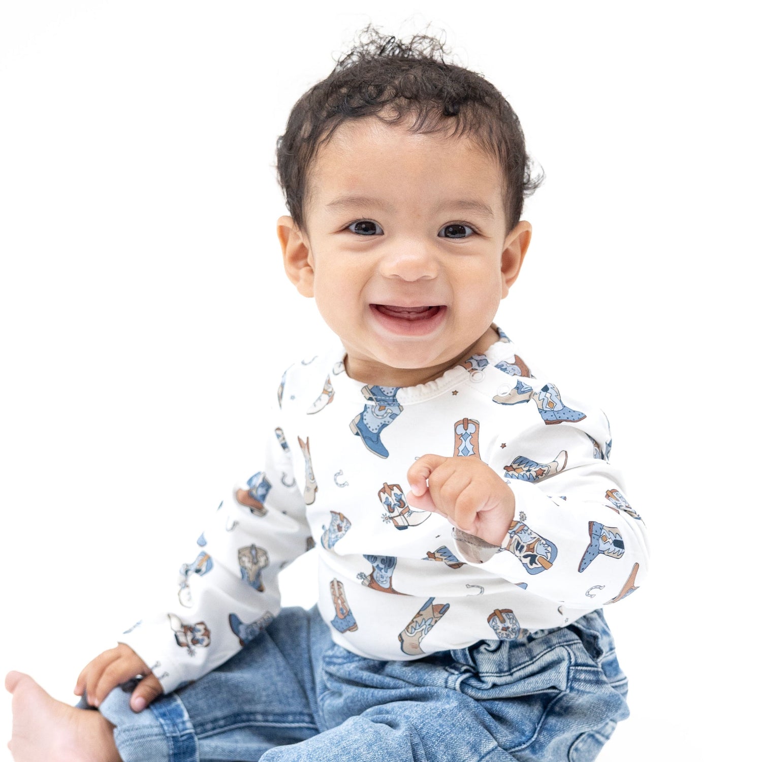 Long sleeve baby bodysuit in a cowboy boot print with snap shoulder and snap crotch closures.