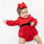 Baby bubble romper in holiday red velour with white Peter Pan collar and velvet ribbon bow accent