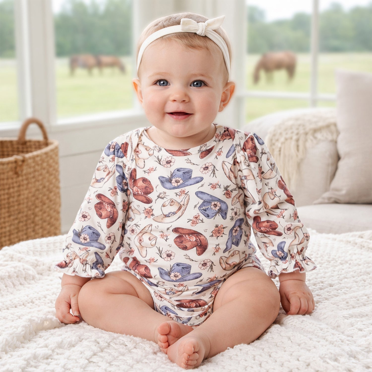 Long-sleeve baby bodysuit in a Wildflower Rodeo cowgirl print with envelope neckline and snap closures
