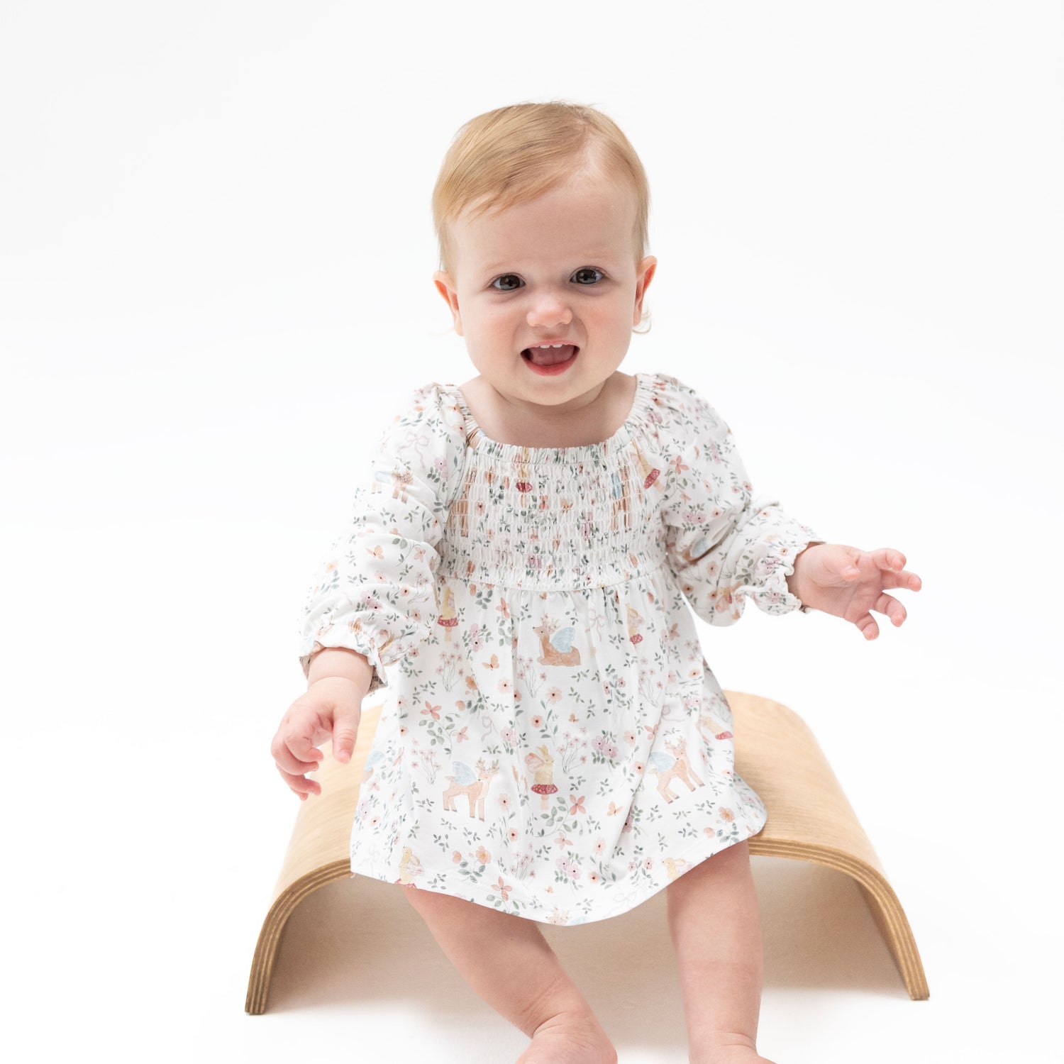 Baby dress and matching bloomer set in an enchanted woodland print with a smocked bodice and ruffled elastic wrists.