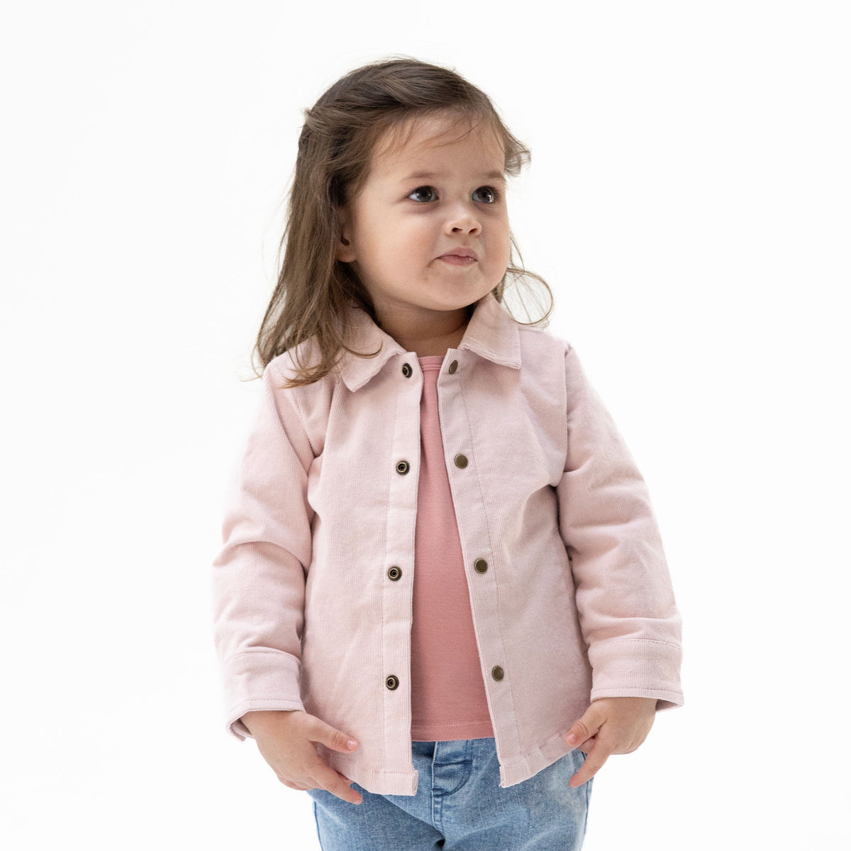 Veiled pink corduroy shirt-jacket for babies with brass cap snaps