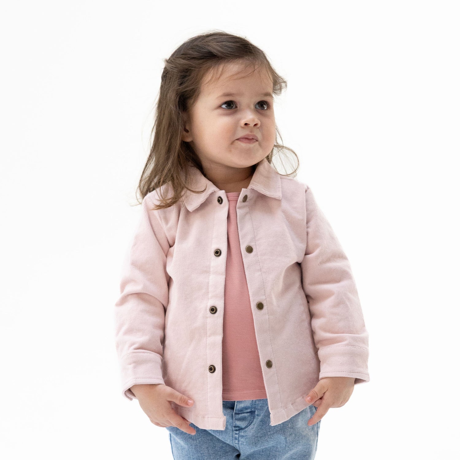 Veiled pink corduroy shirt-jacket for babies with brass cap snaps