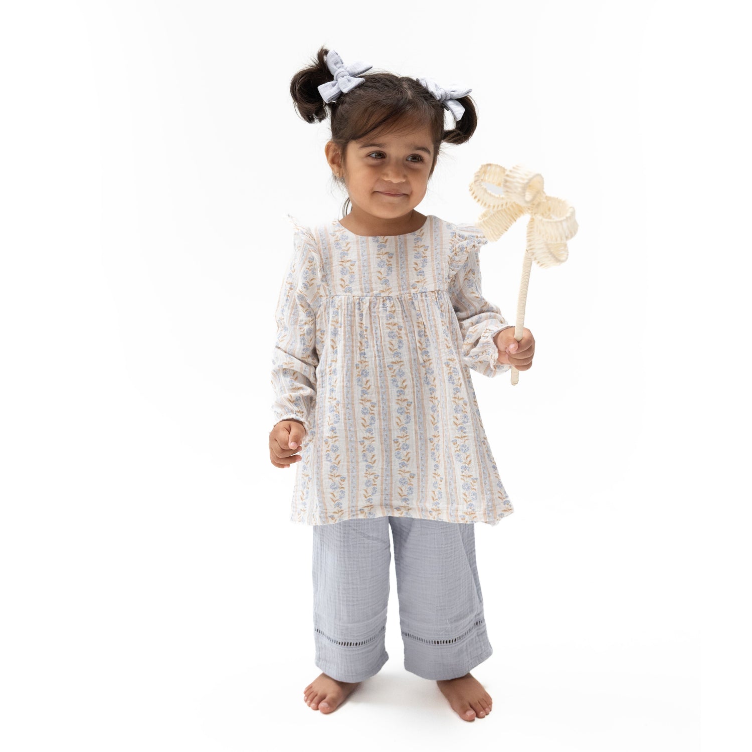 Two-piece set with a floral long-sleeve ruffle tunic and matching smocked-waist pants with ladder trim.