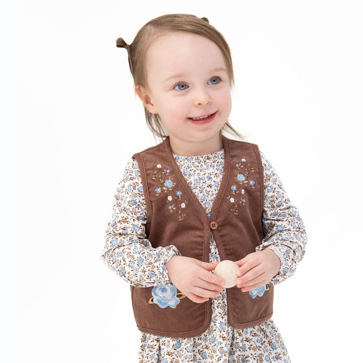 Baby vest in corduroy with embroidered floral details and button loop front closure