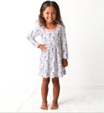 Long-sleeve toddler dress with blue bows, menorahs, dreidels, and Star of David print.