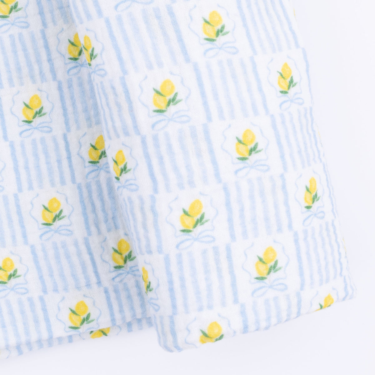 Angel Dear Lovely Lemons Swaddle Blanket featuring a vibrant yellow lemon and green leaf pattern