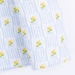 Angel Dear Lovely Lemons Swaddle Blanket featuring a vibrant yellow lemon and green leaf pattern