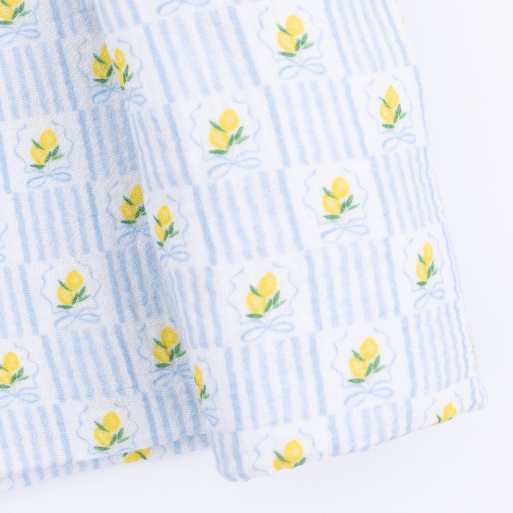 Angel Dear Lovely Lemons Swaddle Blanket featuring a vibrant yellow lemon and green leaf pattern