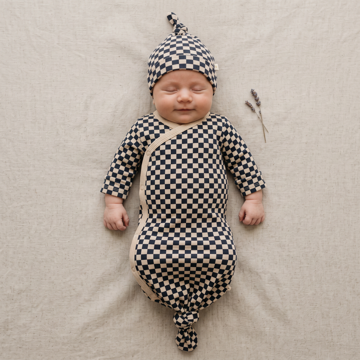 Knotted baby gown in midnight check print with lap shoulder neckline and knotted bottom