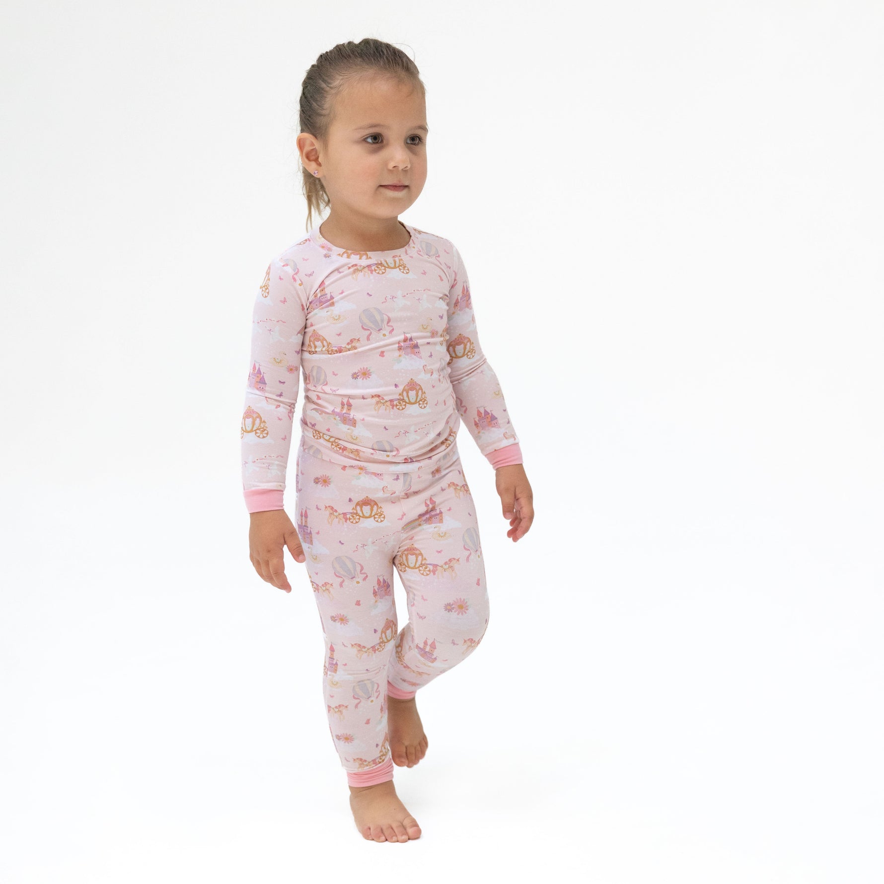 Long sleeve loungewear set with a princess, unicorns, and castle print on the top and matching pants.