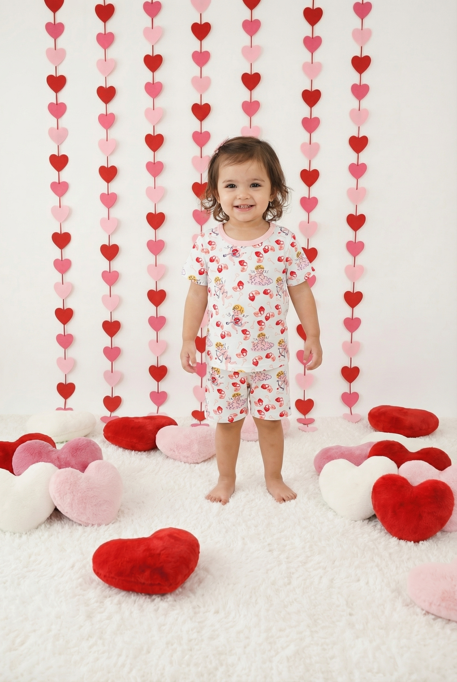 Two-piece baby pajama set with short sleeves and shorts in a cupids bow print